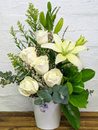 arrangement of white asiatic lilies and white roses